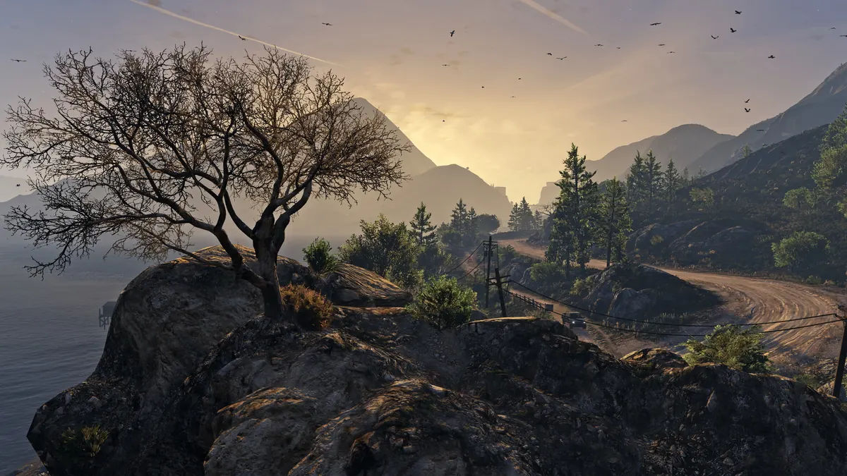 Lone tree on a rocky cliff above the Blaine County countryside at sunset in GTA V