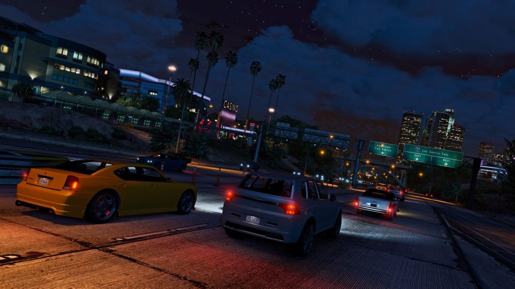 Evening traffic and neon lights reflecting on a Los Santos road