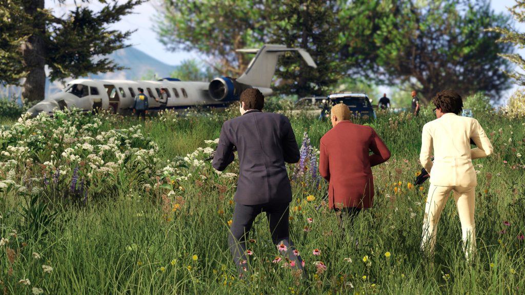 Three men walking through tall grass towards the wreck of a plane